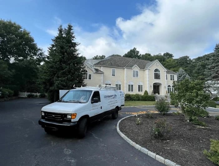 Twinsburg Power Washing technician performing thorough gutter cleaning service in Twinsburg