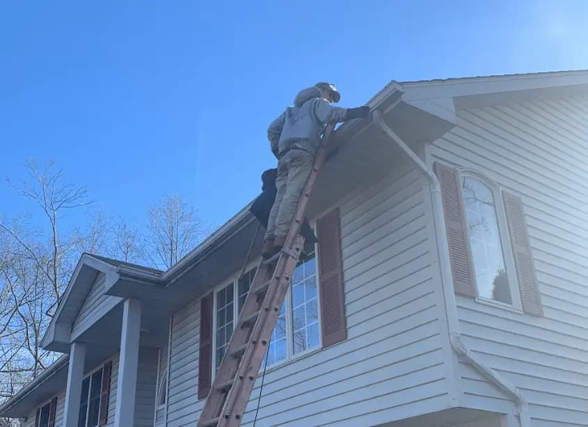 Gutter cleaning and maintenance being performed by Twinsburg Power Washing in Twinsburg